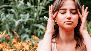 Meditating girl with roller ball essential oil